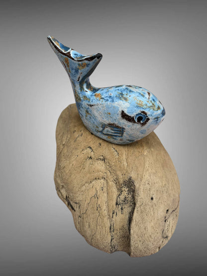 Wooden carved painted whale on wood stand