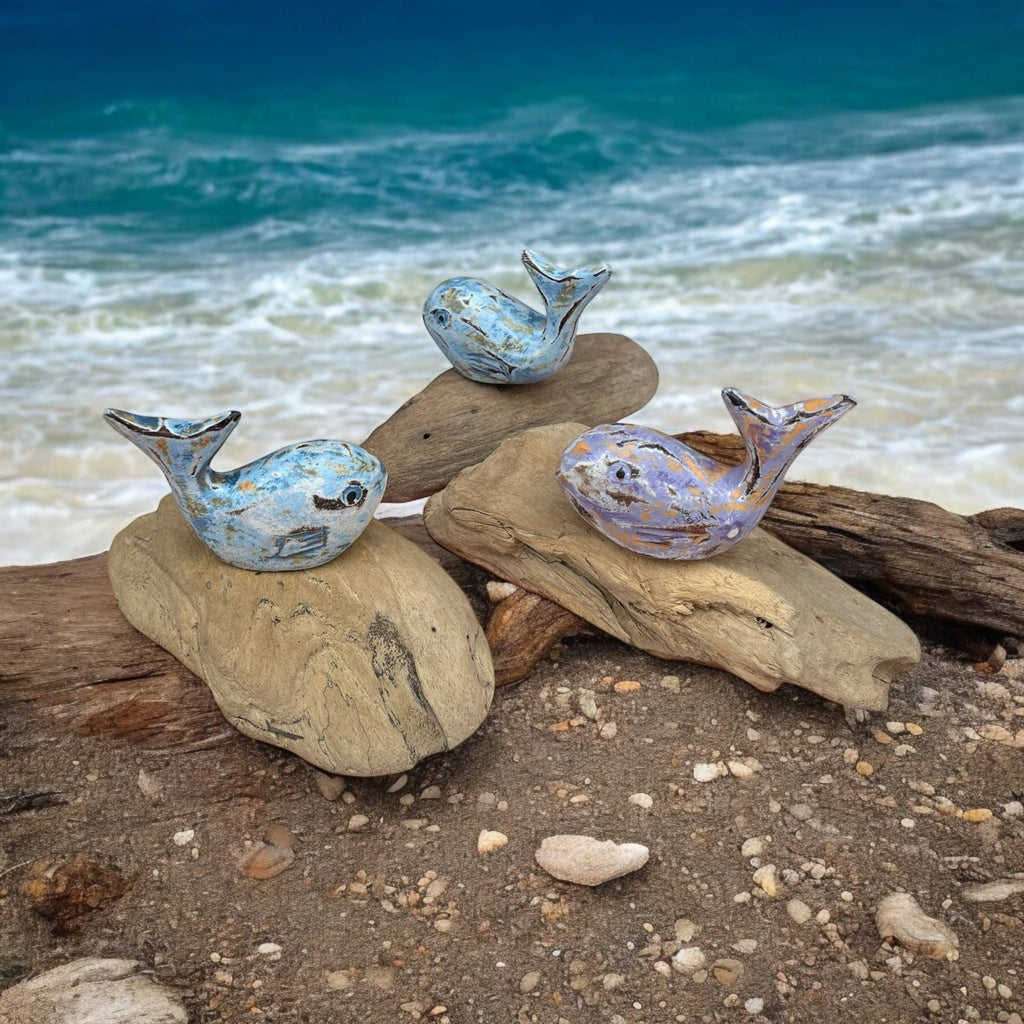 Wooden carved painted whale on wood stand
